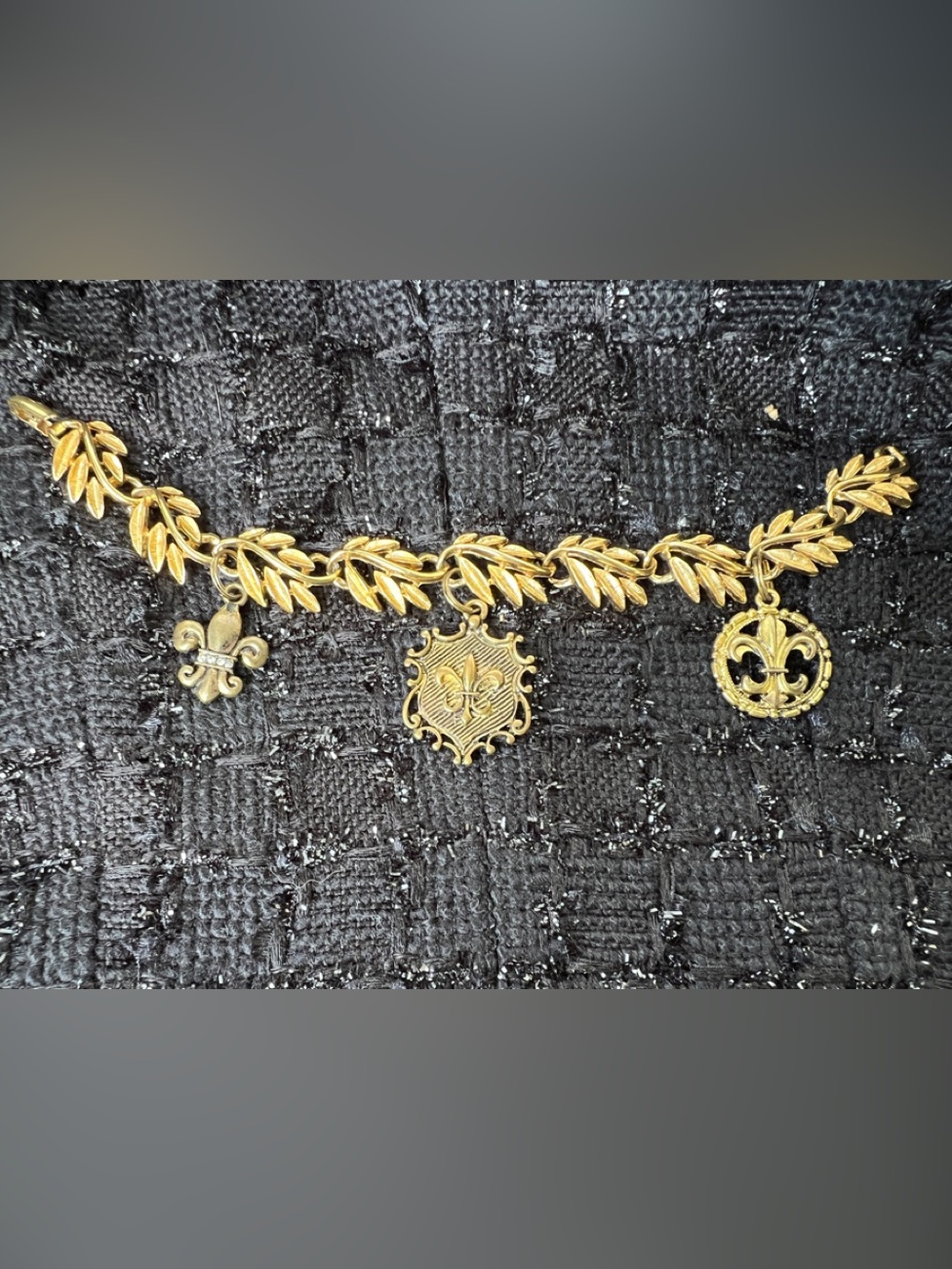 Napier Gold-Tone Laurel Leaf Charm Bracelet with Fleur-de-Lis Shield
